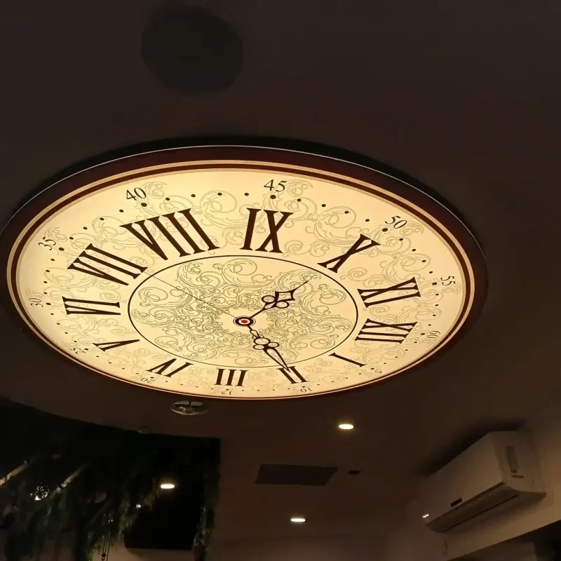 Large ceiling clock with Roman numerals in commercial interior — SignWorks