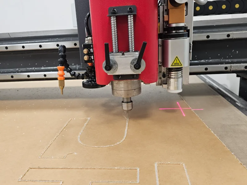 Our CNC router cutting acrylic letters for an illuminated sign