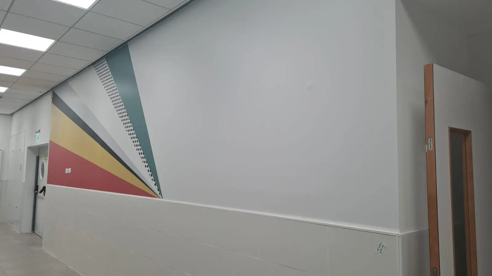Pintura decorativa y gráficos en pared de pasillo de hospital — SignWorks