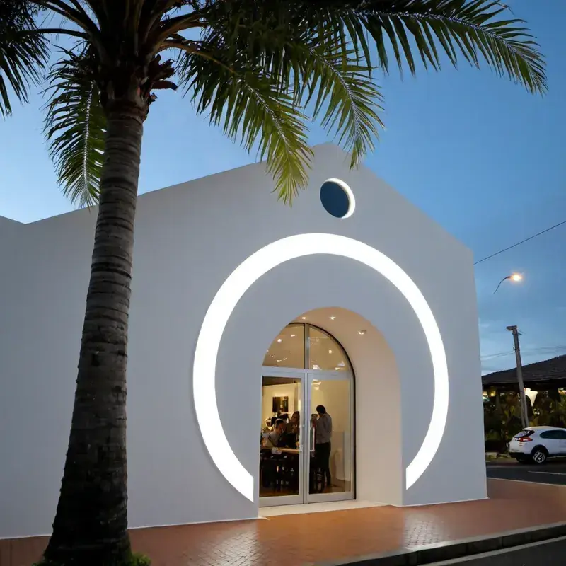 Rótulo de arco 3D iluminado en la entrada de una tienda en Costa Rica