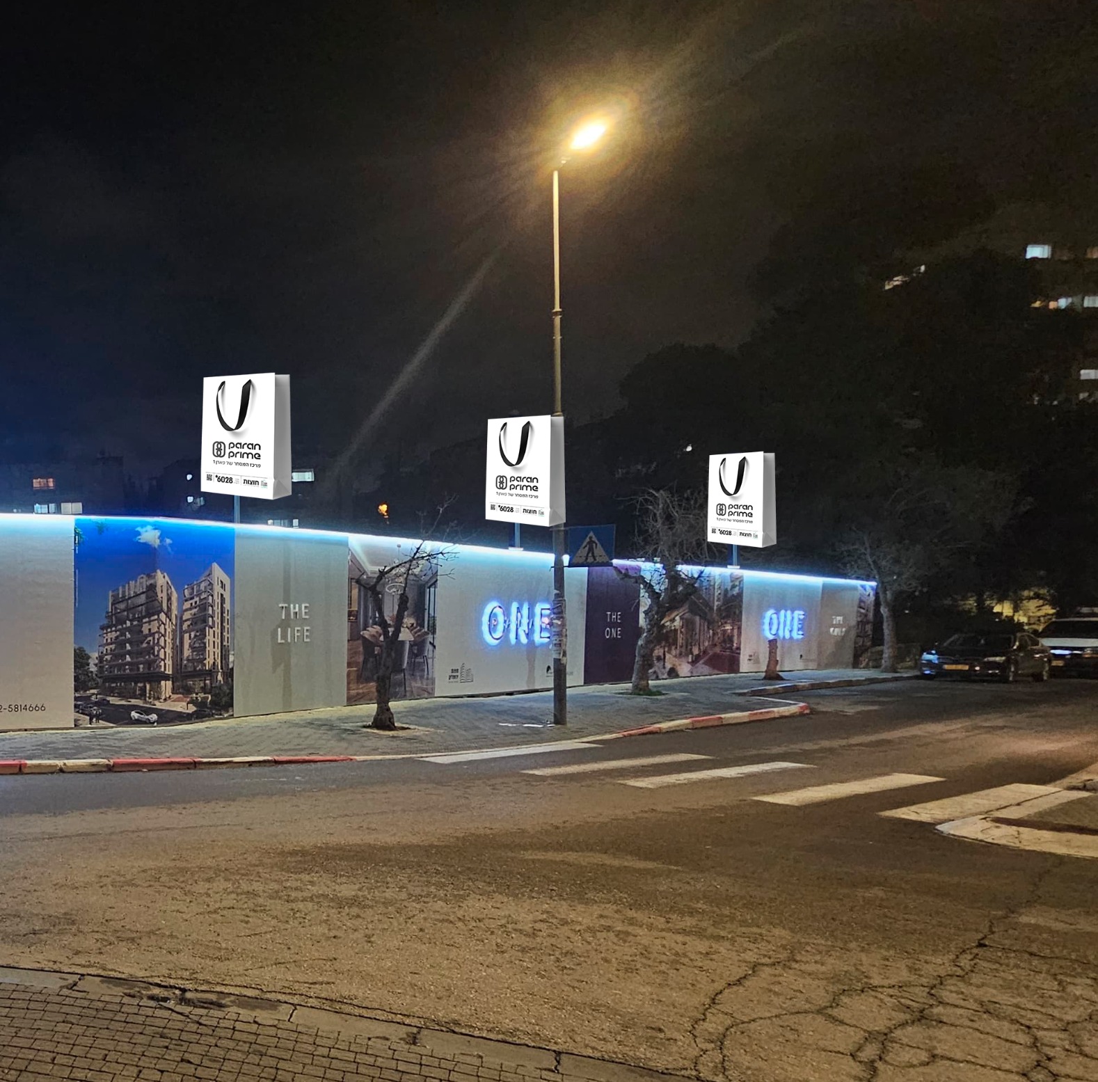 Paran Prime illuminated channel letters on fence with printed objects and iron posts