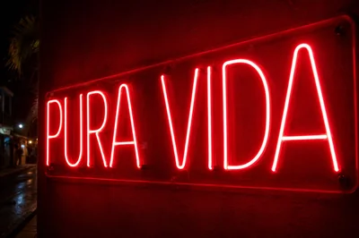 A red LED neon sign reading Pura Vida