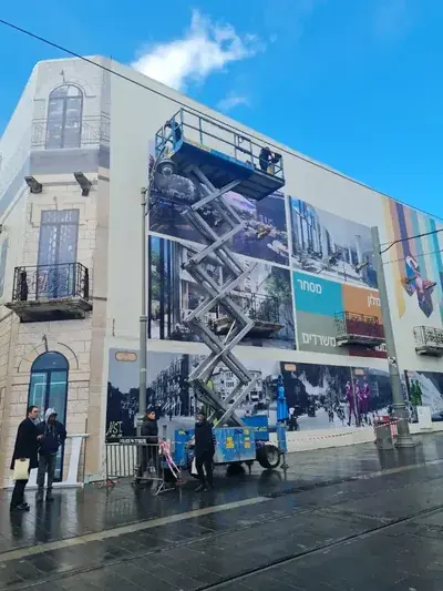 Installers on a scissor lift at a building façade