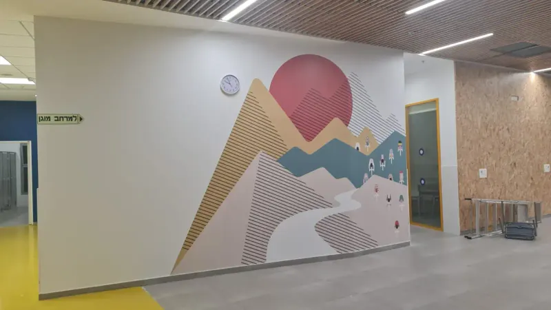 Panoramic wall mural with mountains, river, cyclists and clock — SignWorks