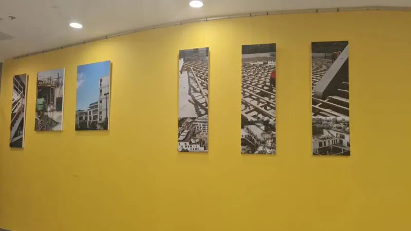 Yellow wall with construction site photo decorations — SignWorks